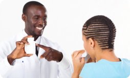 pharmacist showing medicine bottle to his patient